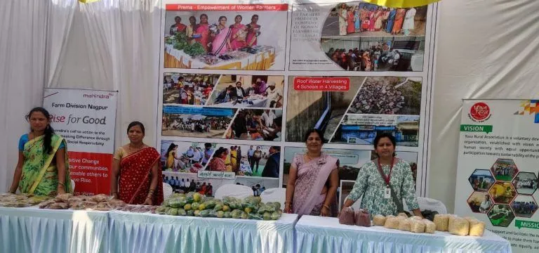 Women selling produce at a livelihood program stall